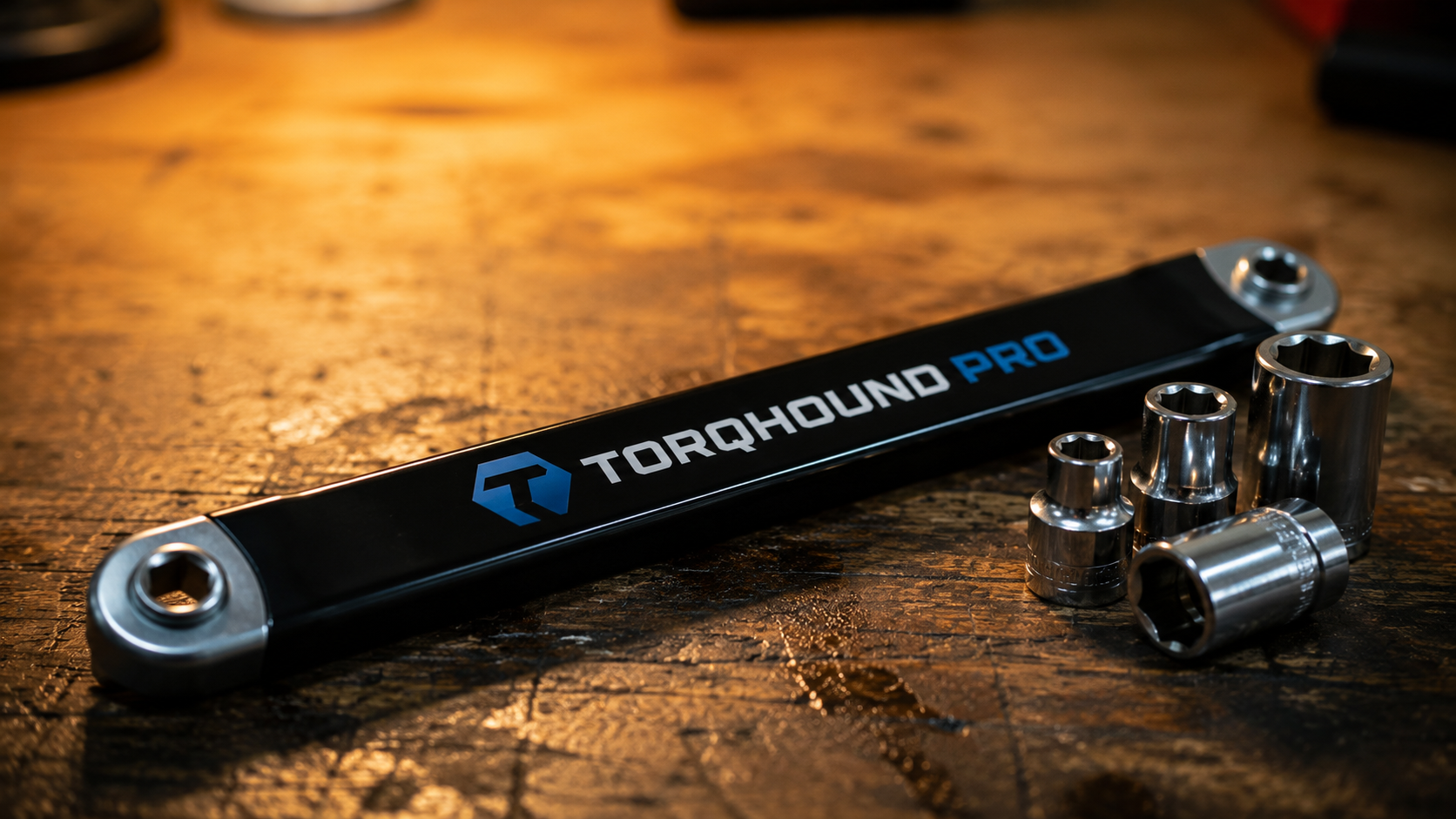 Torqhound Pro wrench alongside standard sockets on a workbench